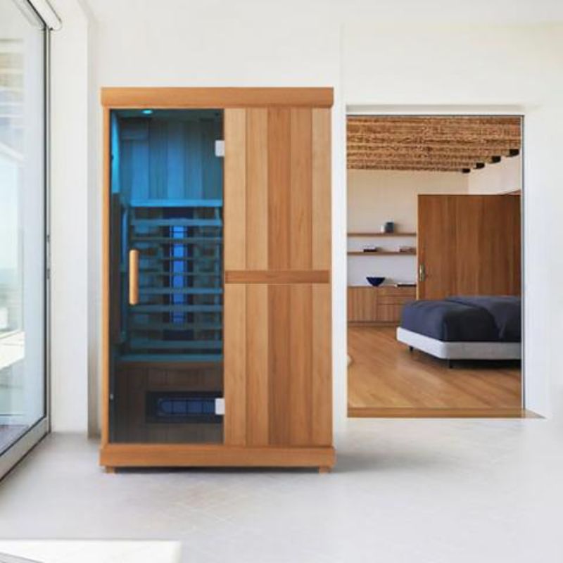 Finnmark Compact 2 Person Full-Spectrum Infrared Sauna - on display outside bedroom, with blue light on