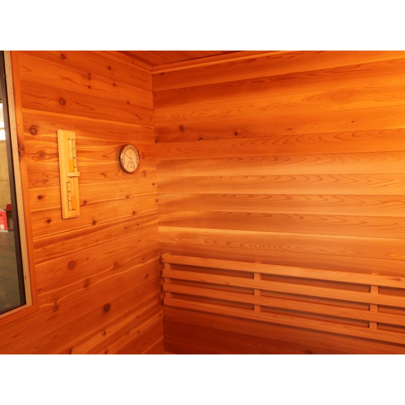 SunRay Seneca HL300DS Home Steam Sauna - interior view of the left wall showing the hygrometer and thermometer on the wall and the far left shows a pice of the tempered glass side window.
