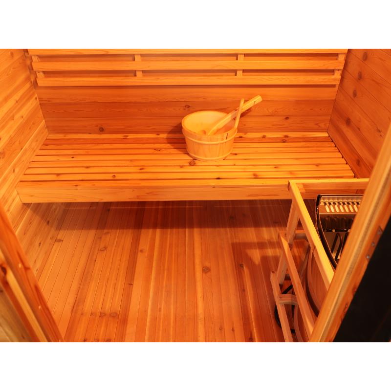 SunRay Seneca HL300DS Home Steam Sauna - interior view downward showing the floor and heater placement to the right. Bucket and ladle on the bench.