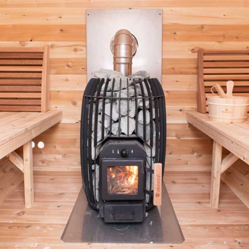 TimberGlow14 Wood Burning Sauna Heater - direct front view with heater between the sauna benches and chimney out the side wall