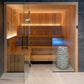 HUUM 9 kW Sauna Heater -HIVE Mini Series - in an indoor sauna, glass door open