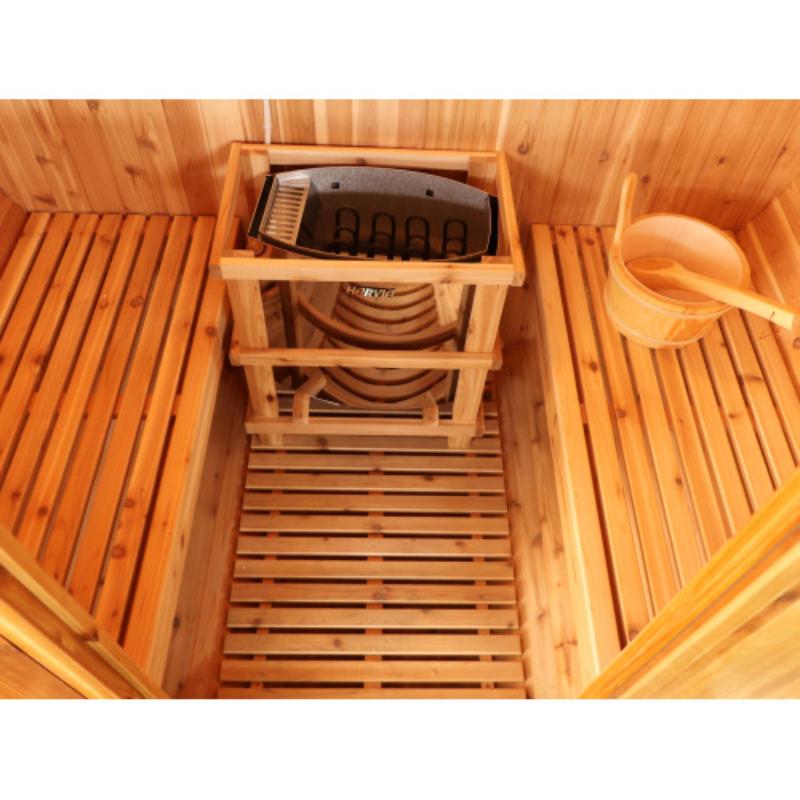 Aurora traditional barrel sauna - interior view of the heater against the wall and between the benches