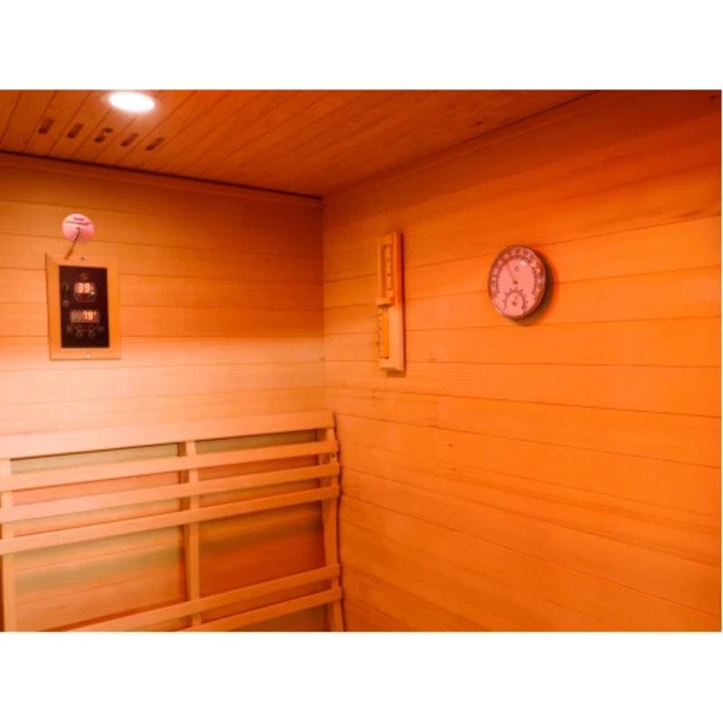 Sunray Eagle 200D1 Outdoor Traditional Steam Sauna - interior showing the control panel on the wall on the left and the sand timer and hygrometer on the wall on the right.