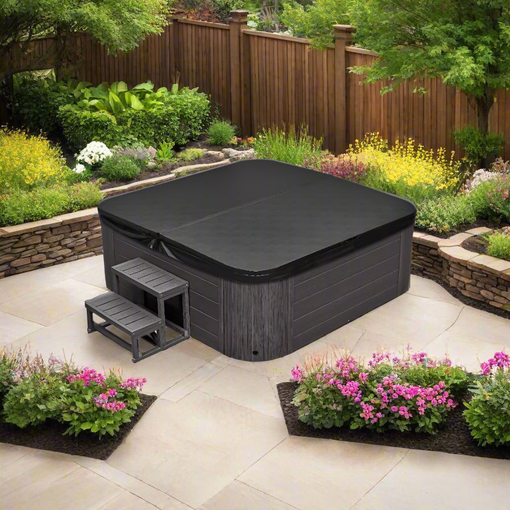 Eclipse 6 Person Hot Tub - full view on a stone patio surrounded by plants