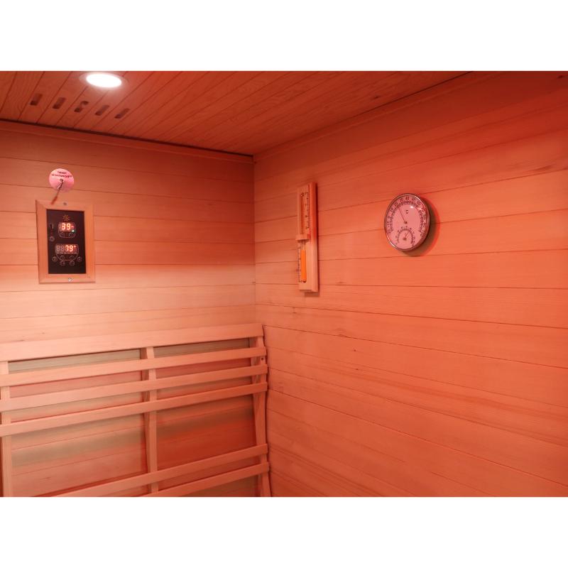 Sunray Freeport 300D1 Outdoor Traditional Steam Sauna - the interior back wall with the control panel (left) and the sand timer and hygrometer on the wall to the right.