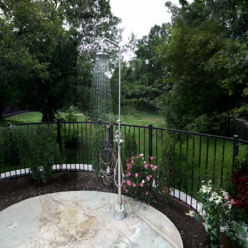 8” Sunflower Shower Head - Hand Spray & Hose - ADA Compliant - on a stone pad in a backyard with flowers and a low iron black fence