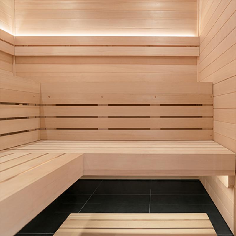 Wooden sauna interior with benches and tiled floor