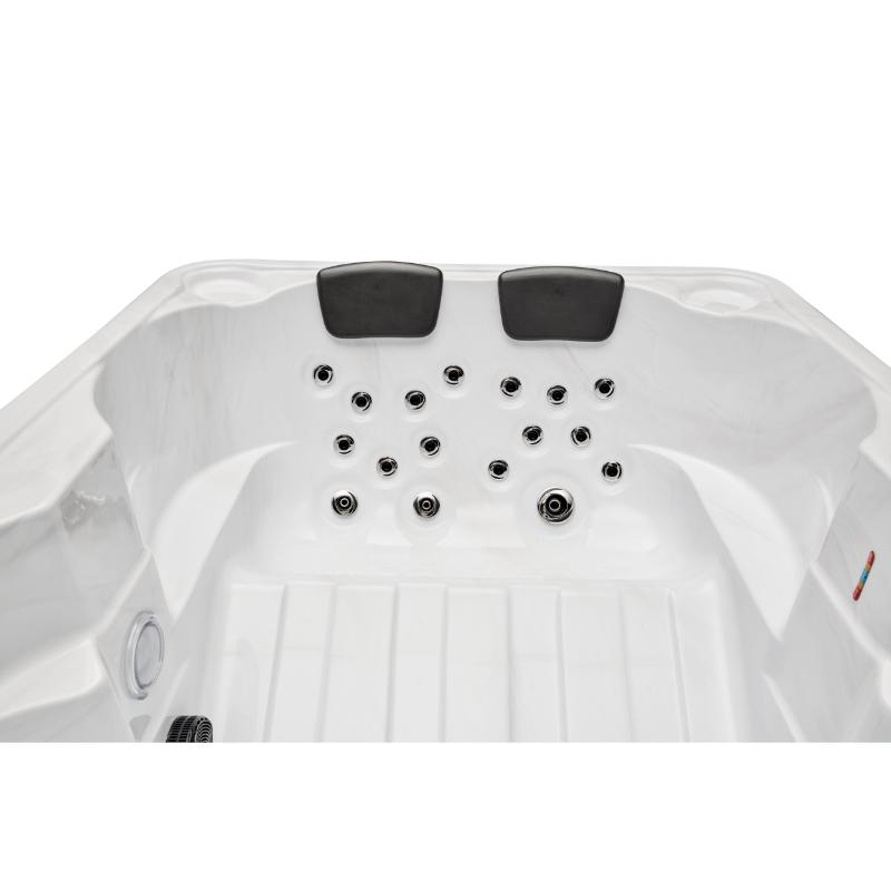 Regal 4 Person Hot Tub - interior view of 2 end seats with headrests and jets. No water.