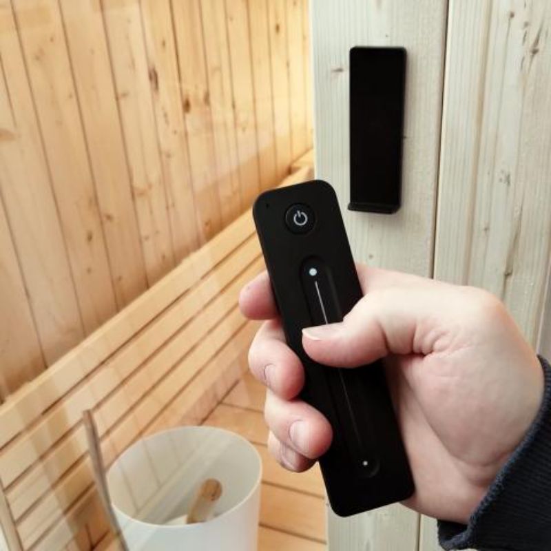 SaunaLife 3 Person Indoor Home Sauna Model X6 - hand holding white LED light bar remote