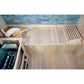 Westlake 3 Person Traditional Sauna - interior downward view of bench with Harvia heater on the left, as well as water bucket. On he right side of the bench is a backrest.