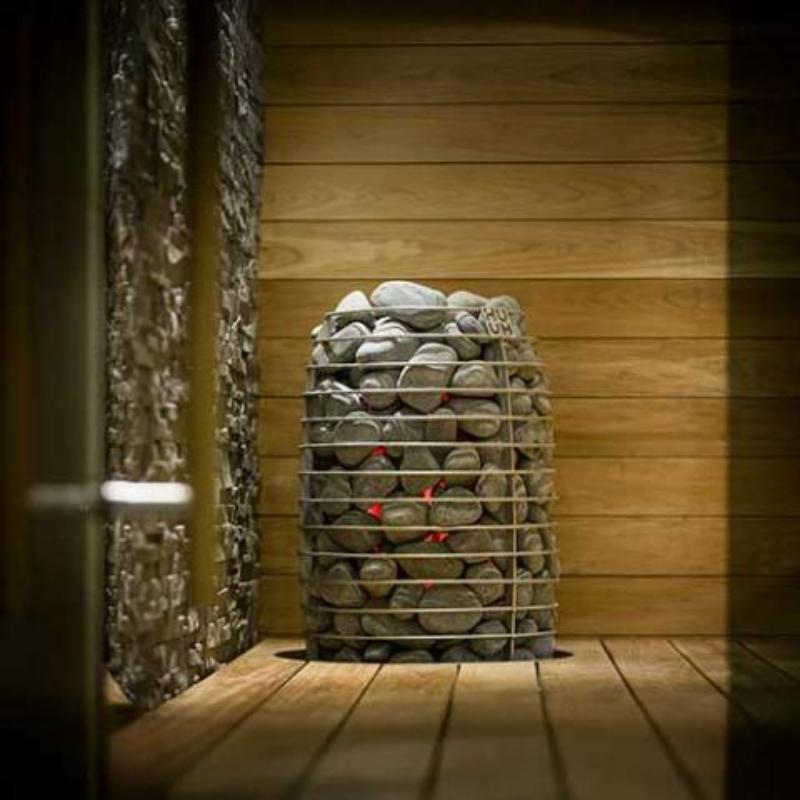 HIVE Mini Series 10.5kW Sauna Heater in installed, in use and showing orange glow between the rocks in the heater