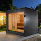 Sauna Life G7 Pre-Assembled Outdoor Home Sauna - on a concrete patio at night showing the interior lights