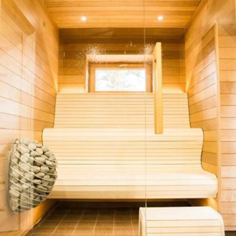 Custom sauna with HUUM Drop sauna heater mounted on the wall