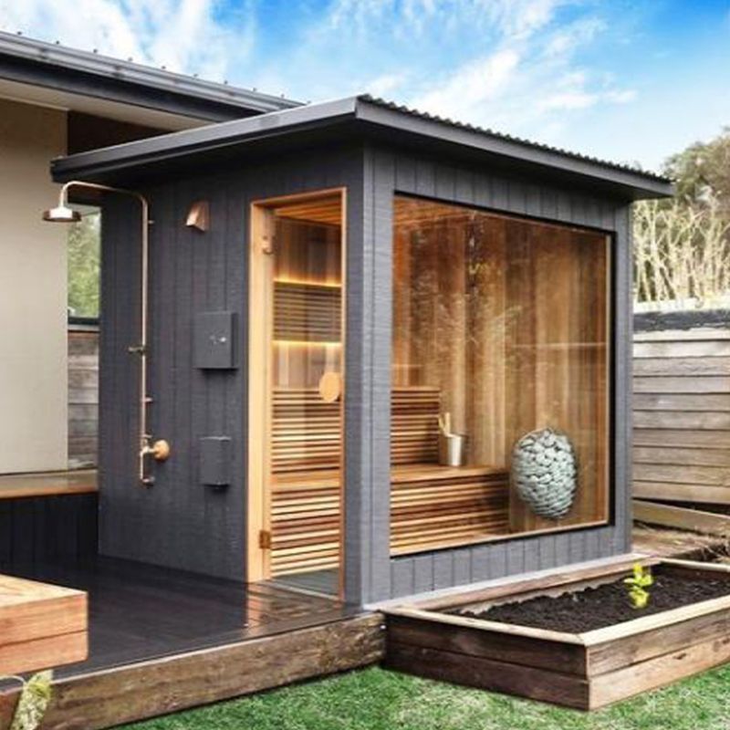 Custom outdoor sauna with the HUUM Drop sauna heater mounted on the interior wall