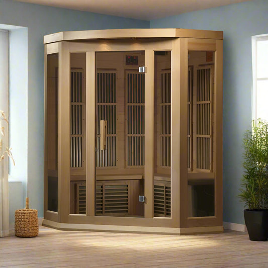 Maxxus MX-K356-01 ZF Corner Infrared Sauna - full view flanked by windows and a plant on the right